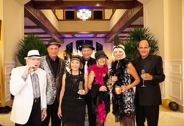 BallenIsles Members share a toast in BallenIsles Grand Lobby during Great Gatsby-style Soiree celebrating $35 million Clubhouse Grand Opening